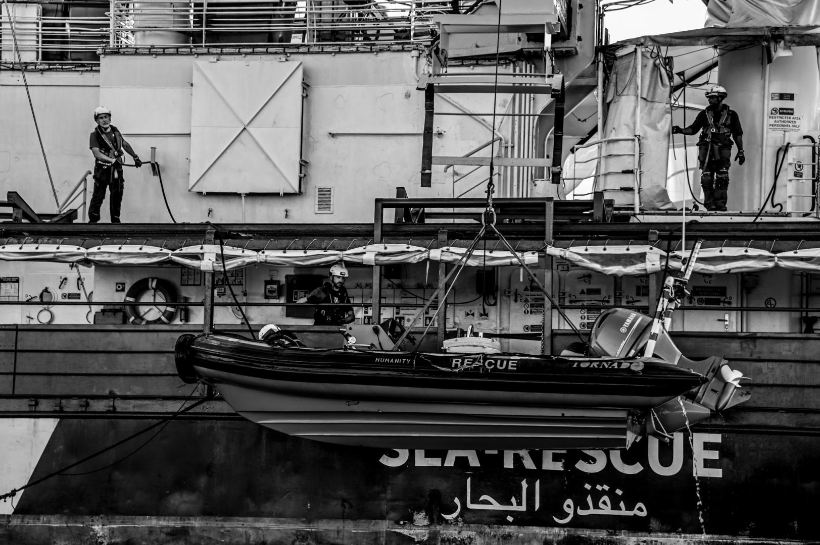 After a rescue, Tango is recovered and winched back aboard Humanity 1