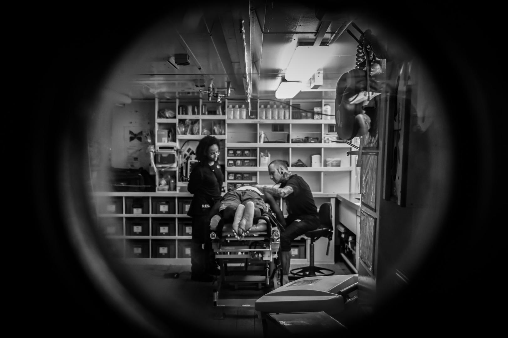 The onboard hospital; consisting of a doctor, nurse, and midwife, practices receiving casualties.