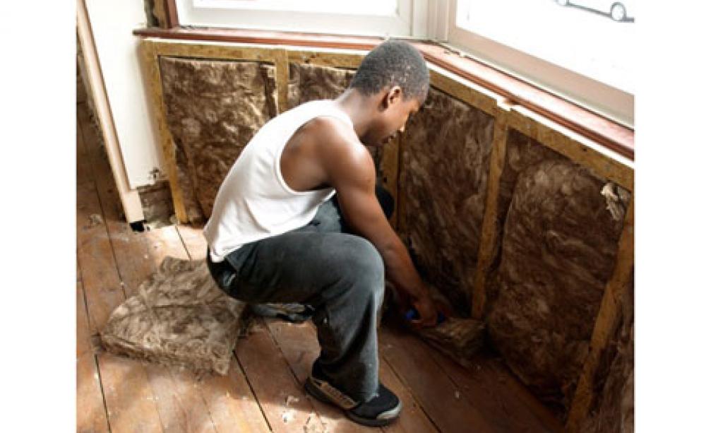 Sue's son Yeshaya helping put in the Ecobatt insulation