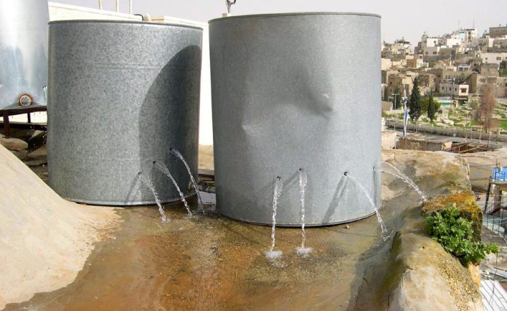 Holed Palestinian water tanks, destroyed by armed settlers in the old city of Hebron. Photo: ISM Palestine via Flickr (CC BY-SA).