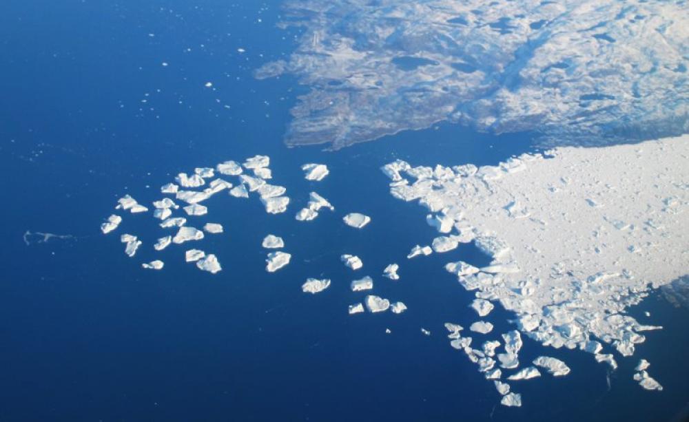 A Greenland glacier breaks up into pieces into Ilulissat Icefjord. With rising sea levels and warming temperatures, such events are becoming ever more frequent. Photo: Tim Norris via Flickr (CC BY-NC-ND).
