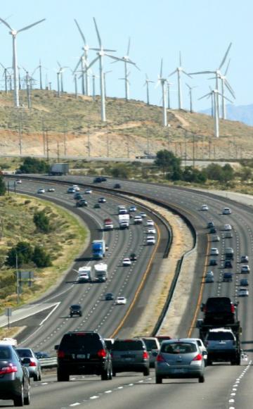 For some decades to come, old and new energy systems will have to maintain an uneasy coexistence - as at Interstate 10 near Palm Springs, California. Photo: Kevin Dooley via Flickr (CC BY).