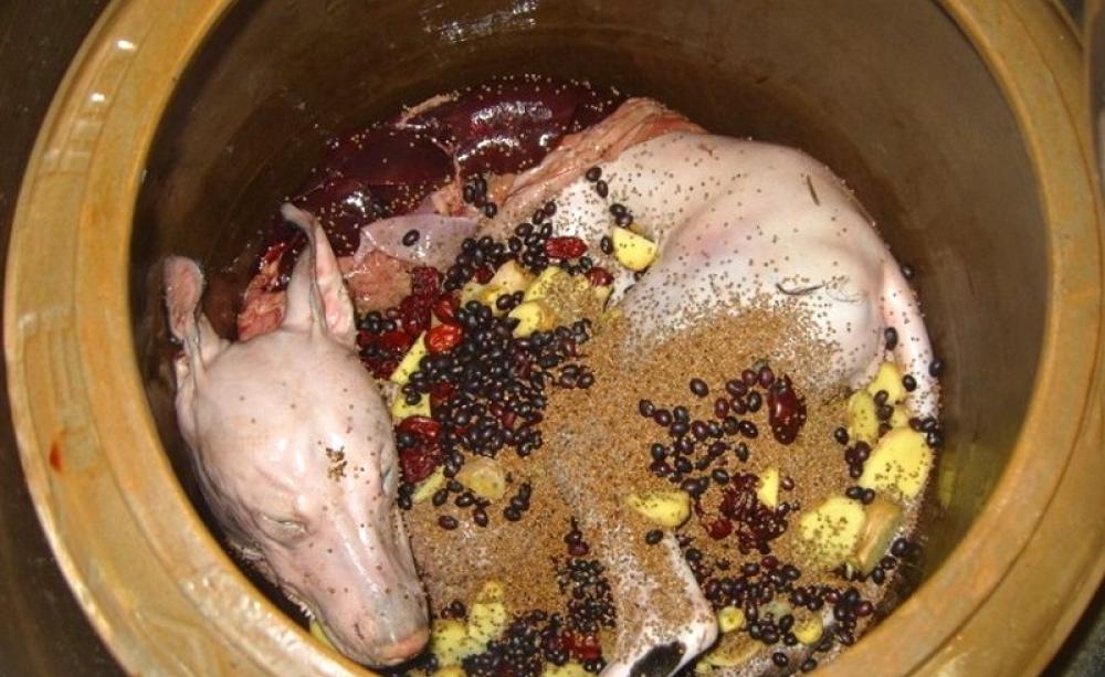 A flayed whole dog placed in a cooking pot with other ingredients to make the 'dog elixir' soup for South Korea's 'Boknal' festival. Photo: courtesy of Anneka Svenska.