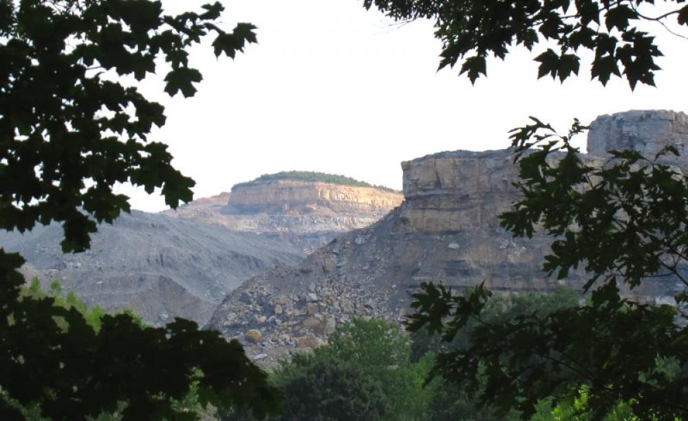 Fossil fuels are already a huge money pit for US taxpayers, costing them $170 billion a year. Photo: open pit coal mine in West Virginia by Elias Schewel via Flickr (CC BY-NC-ND).