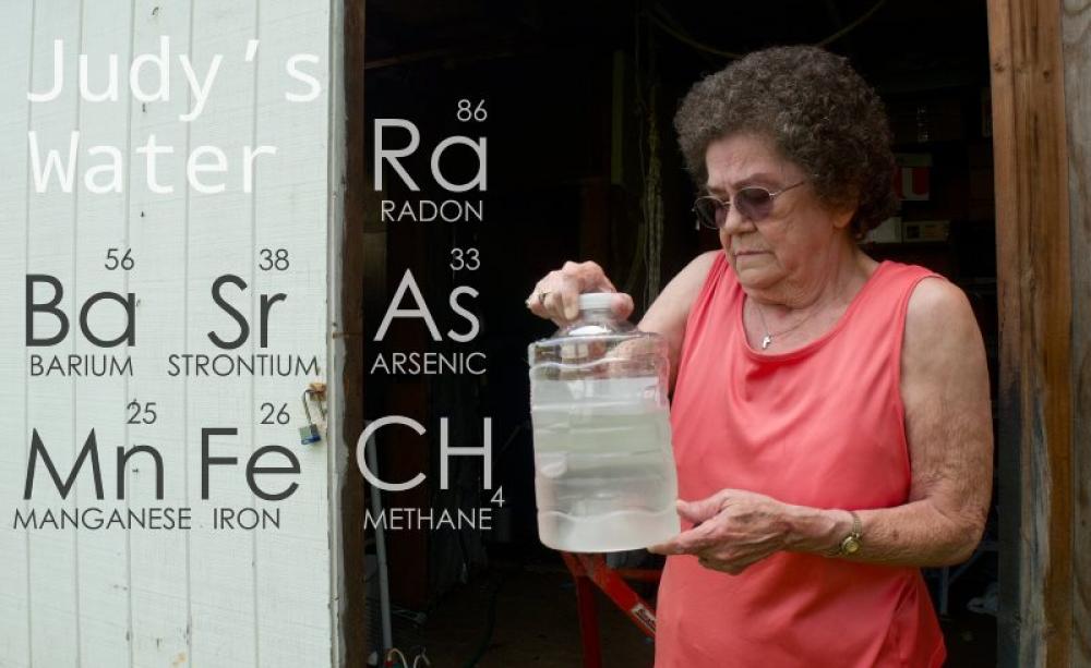 Judy Eckert holding water contaminated with arsenic drawn from her private well 450ft from a fracking rig in Pennsylvania, which she believes contaminated her water supply. Photo: Public Herald via Flickr (CC BY-NC-ND).