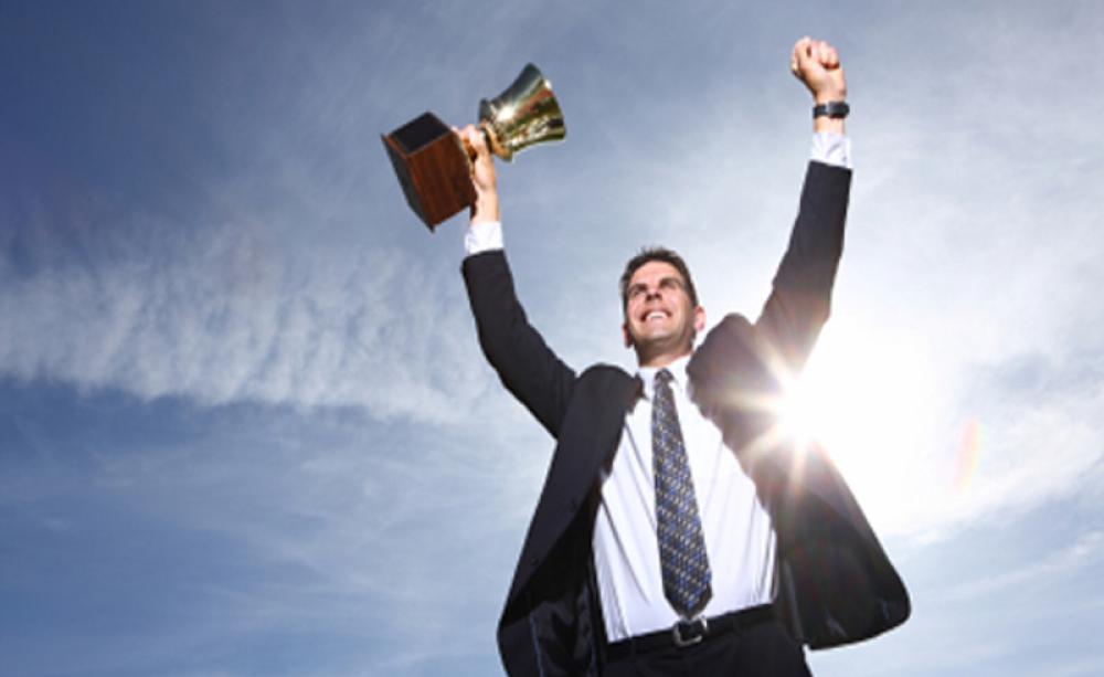 A businessman celebrates a win