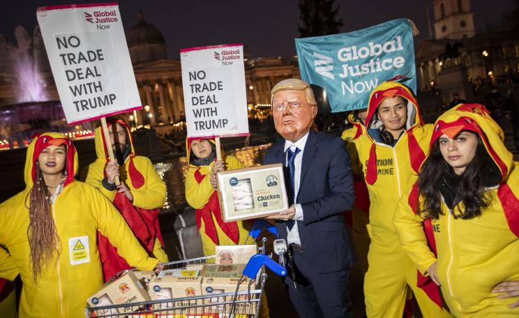 Protestors dressed as chickens march against US president Donald Trump