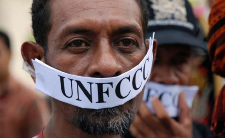Gagged protester at COP19 in Warsaw. Photo: Langelle / GJEP-GFC.