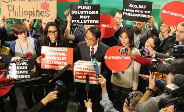 The world stood with Yeb Sano and the Philippines in 2013 - but now the Philippines are dumping him and the principled policies he represented. Photo: Handing over 600k solidarity messages to Yeb Sano at the Warsaw COP, by Push Europe (CC BT-NC 2.0).