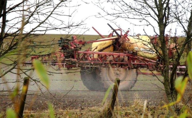 Agrochemicals are routinely sprayed right up to the boundary line with residential properties, causing severe ill-health to rural residents. Photo: UK Pesticides Campaign.