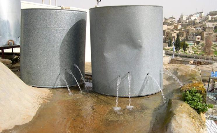Holed Palestinian water tanks, destroyed by armed settlers in the old city of Hebron. Photo: ISM Palestine via Flickr (CC BY-SA).
