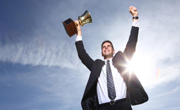 A businessman celebrates a win